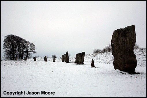 Standing stones in the snow at Avebury Stone circle in Wiltshire.